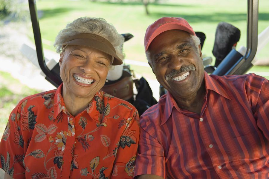Smiling couple in a golf cart