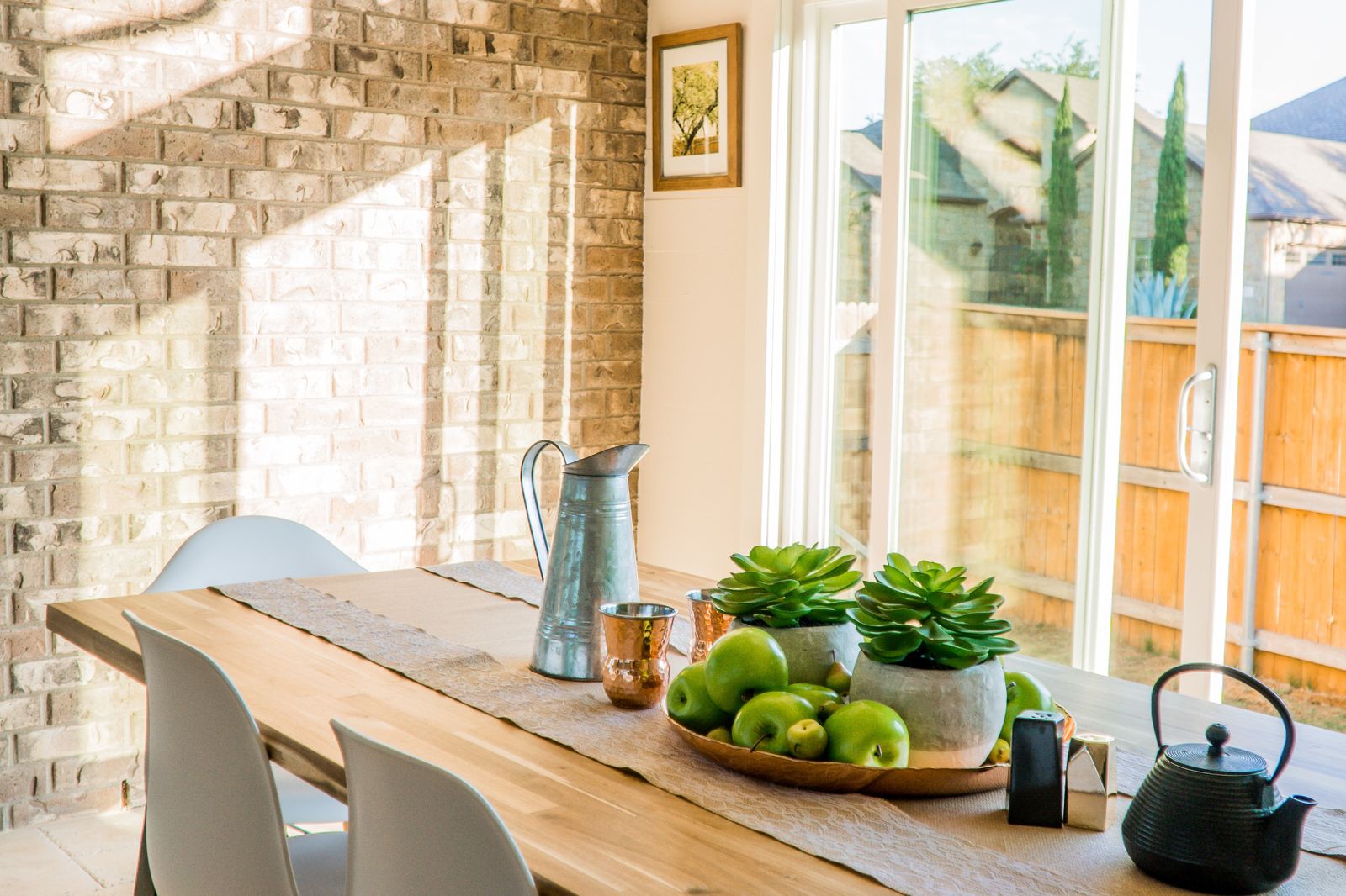 Sunlit family kitchen and dining table in a new Arizona home