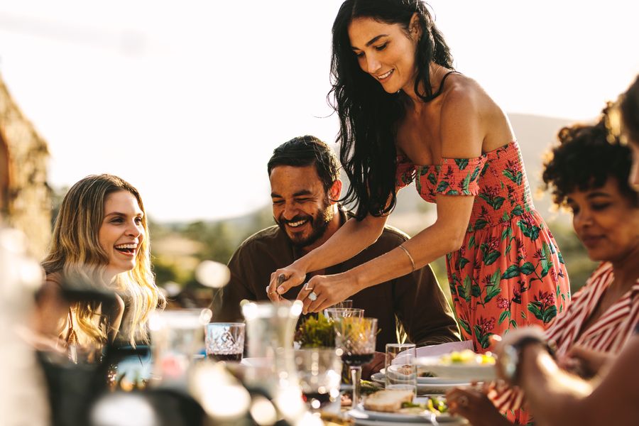 Friends sharing an outdoor dinner party at golden hour